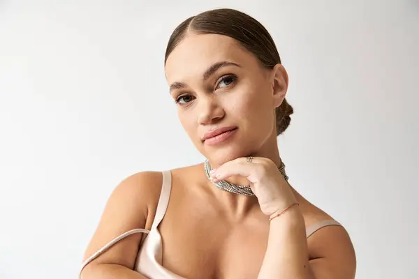 A young woman in a chic studio showcases fashion, promoting inclusivity and style. — Stock Photo