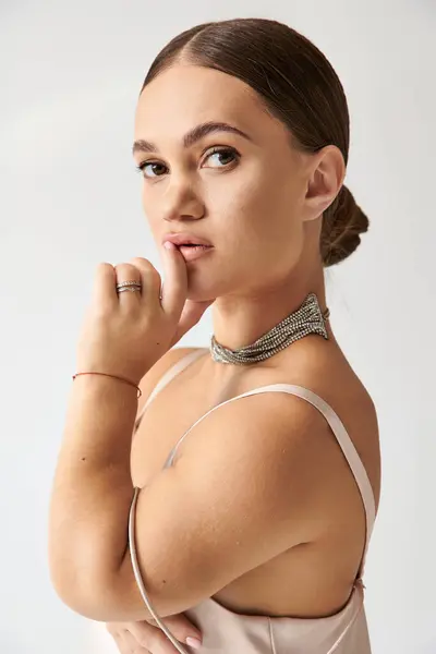 A young woman with short stature poses gracefully in an elegant dress, showcasing style. — Stock Photo