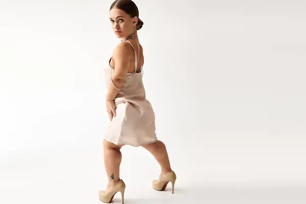 A young woman confidently showcases her style in a fashionable dress, celebrating diversity. — Stock Photo