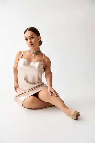 Stylish young woman with short stature poses gracefully in a chic studio environment. — Stock Photo