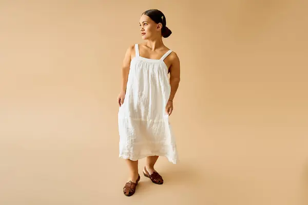 Young woman with short stature showcases elegance in a pretty white dress. — Stock Photo