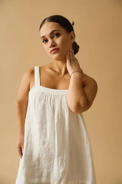 A young woman with short stature models a pretty dress in a studio, celebrating diversity. — Stock Photo