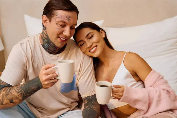 Two affectionate partners enjoy each others company while sipping coffee in a cozy space. — Stock Photo