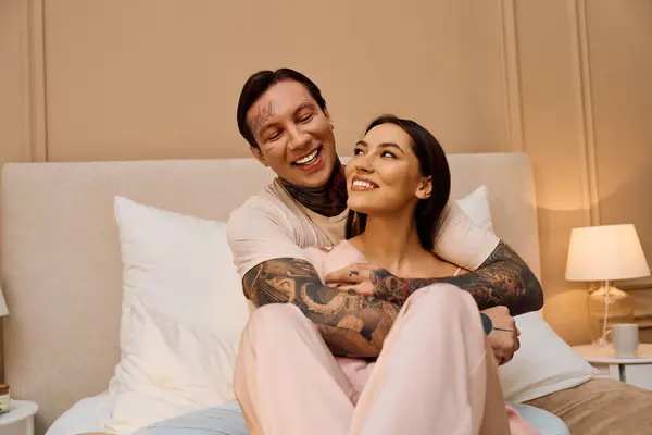 A young couple enjoys each others company, radiating love and happiness in their cozy room. — Stock Photo