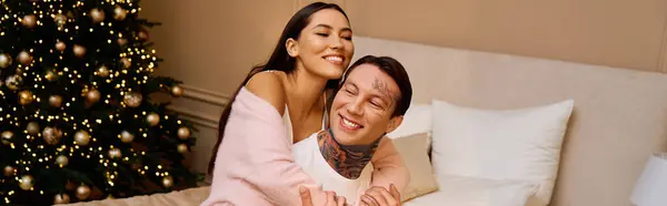 Couple embraces each other lovingly, surrounded by a warm ambiance and holiday decorations — Stock Photo