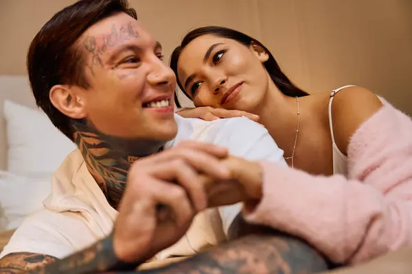 Young couple enjoys each others company while embracing in a comfortable indoor space. — Stock Photo