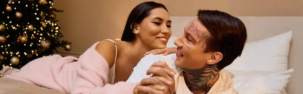 Young couple smiles and shares tender moments while relaxing in a warm holiday atmosphere — Stock Photo