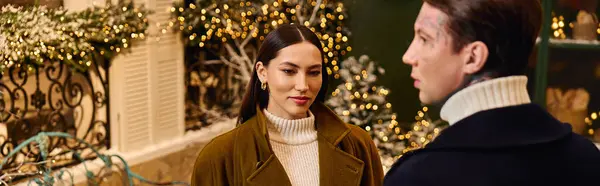 Two lovers connect warmly among twinkling holiday lights and winter decorations. — Stock Photo