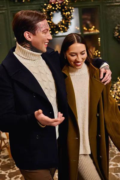 Smiling couple embraces the magic of the holidays with joy and love in their eyes — Stock Photo