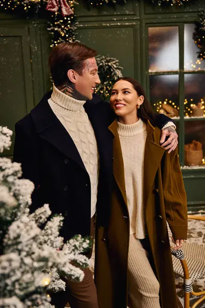 Loving couple revels in each others presence while surrounded by charming winter decorations. — Stock Photo