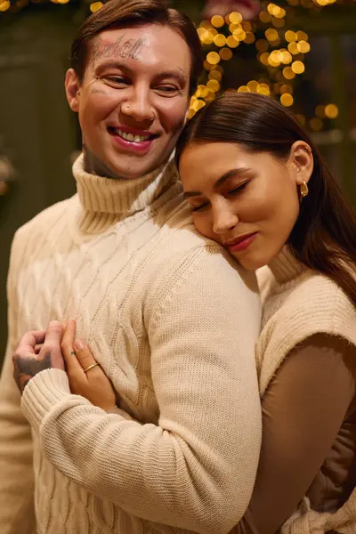 Love shines brightly as a young couple cuddles warmly in a festive atmosphere. — Stock Photo