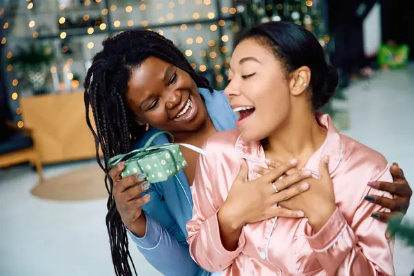 Two women share a heartfelt moment, surrounded by twinkling lights and warmth of togetherness. — Stock Photo