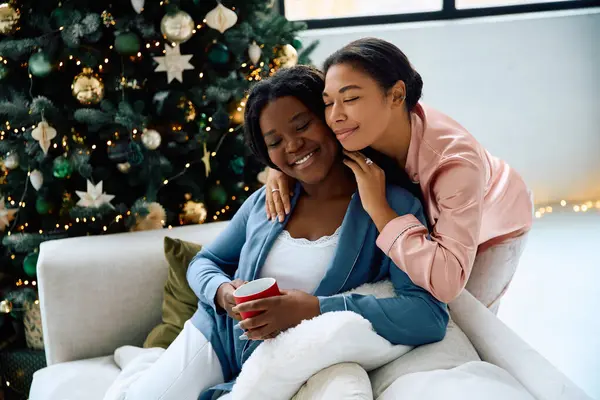 Two women share love and laughter while enjoying a festive moment together. — Stock Photo