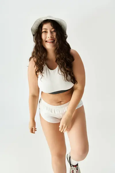 Young plus size woman showcases beautiful and stylish underwear while smiling joyfully. — Stock Photo