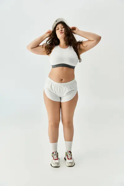 Young plus size woman poses with confidence in stylish underwear and relaxed footwear indoors — Fotografia de Stock