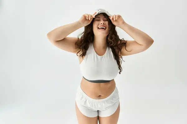 Young plus size woman showcases her beauty and style while smiling joyfully and posing playfully. — Stock Photo