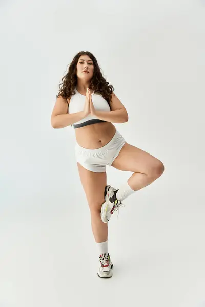Young plus size woman practices yoga in trendy underwear, radiating beauty and self assurance. — Stock Photo