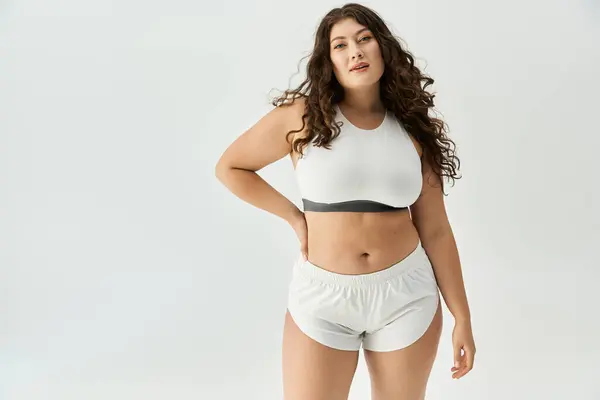 Plus size woman flaunts stylish underwear, celebrating body positivity and fashion. — Stock Photo