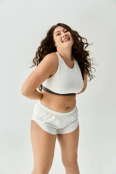 Bright and cheerful atmosphere as a young woman showcases beautiful plus size underwear fashion. — Stock Photo