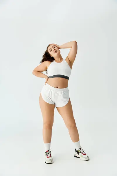 Young plus size woman showcases stylish underwear with a confident pose in a bright setting. — Fotografia de Stock