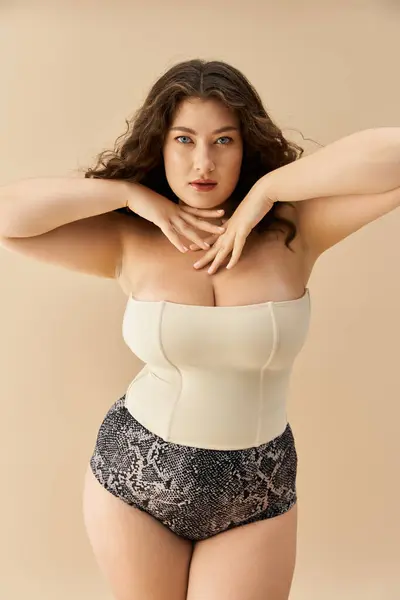 Young plus size woman poses confidently in fashionable underwear against a minimalist backdrop. — Stock Photo