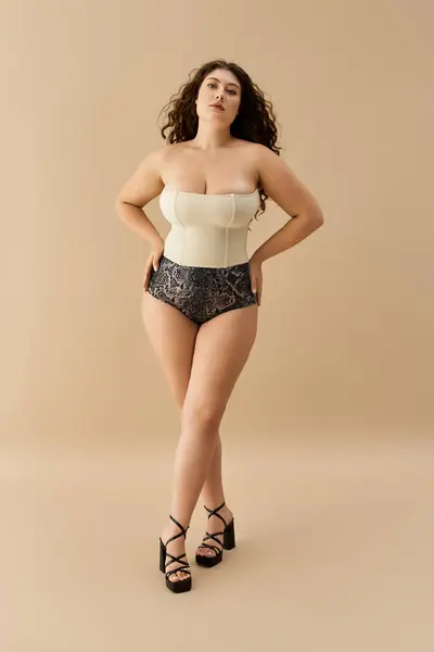 Plus size woman elegantly models trendy underwear against a neutral backdrop. — Stock Photo