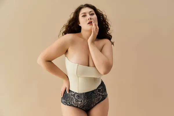 Young woman in fashionable underwear showcases beauty and self expression with poise and style. — Stock Photo