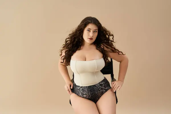 A confident young plus size woman poses in stylish underwear, embracing her beauty and fashion. — Stock Photo