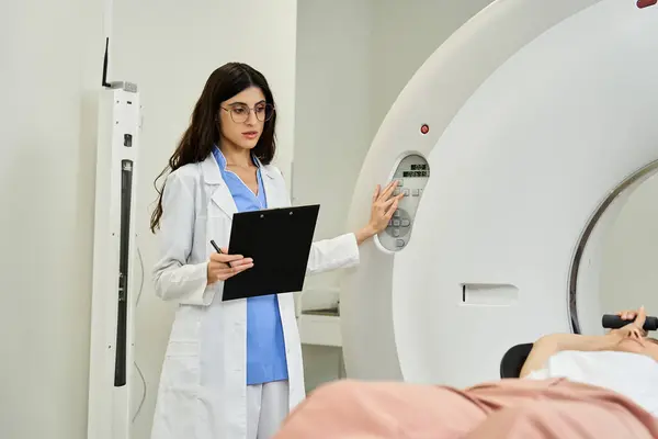 A doctor in a lab coat guides a patient through an MRI scan process in a hospital room. — Stock Photo