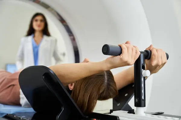 A skilled doctor monitors a patient positioned in an MRI machine for diagnostic imaging. — Stock Photo