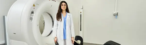 Attractive female doctor in a lab coat oversees diagnostic procedures in a hospital room. — Stock Photo