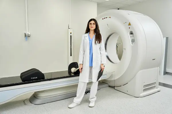 Attractive female doctor in a lab coat is readying for patient diagnostics in radiology. — Stock Photo