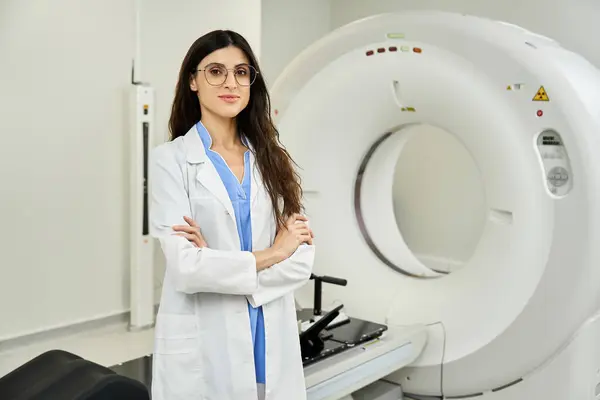 Female doctor in lab coat ensures patient care in the radiology department. — Stock Photo