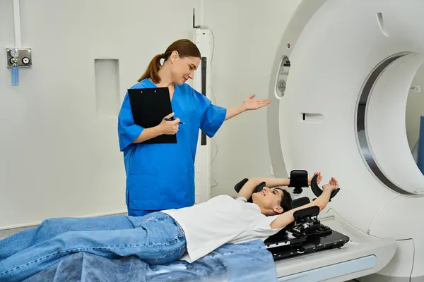 Doctor discusses MRI scanning process with patient lying in machine as part of diagnostics. — Stock Photo