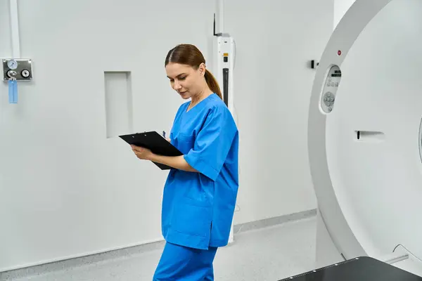 Radiologist in scrubs diligently assesses patient information in a hospital setting. — Stock Photo