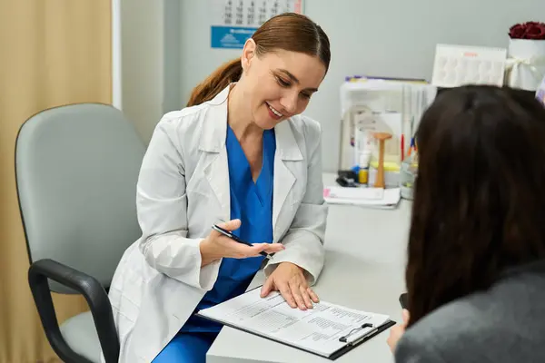 A gynecologist listens attentively while consulting a female patient about health concerns. — Stock Photo