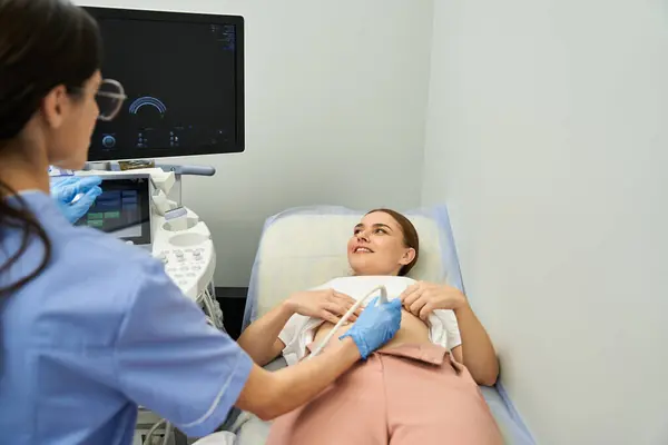 A gynecologist performs a medical checkup on a female patient in a contemporary clinic. — Stock Photo