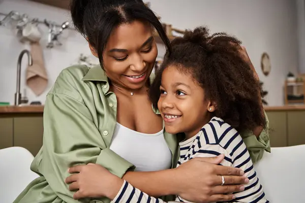 A joyful bond shared between a mother and her daughter sparkles with laughter and love indoors. — Stock Photo