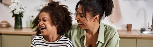 A loving mother and her daughter share a beautiful moment filled with laughter and joy at home. — Stock Photo