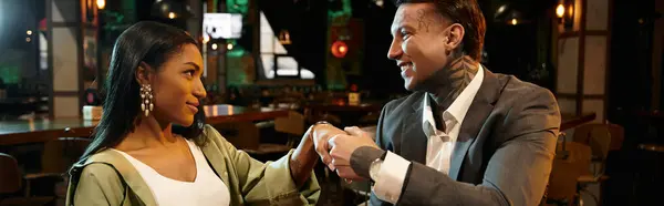 A beautiful couple shares a moment of affection during their night out together. — Stock Photo