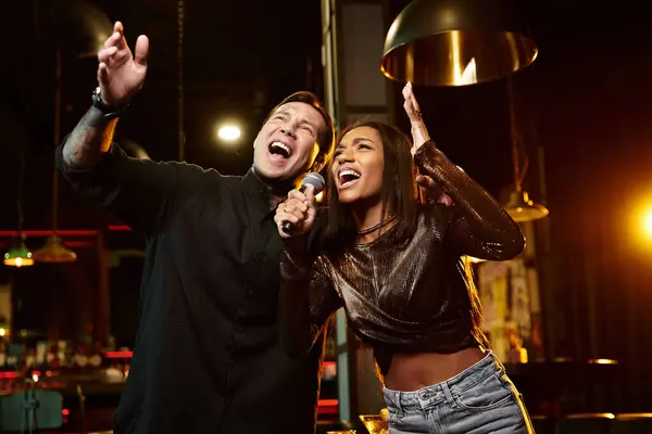 Young couple sharing laughter and music on a fun night out in an urban bar atmosphere. — Stock Photo