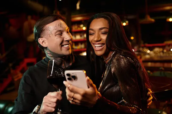 A tattooed couple shares smiles and laughter while exploring the bar scene together. — Stock Photo