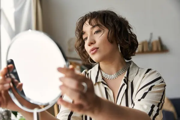 A young woman with curly hair enjoys her beauty routine in a bright, stylish apartment. — Stock Photo