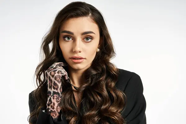 Elegant young woman confidently showcases her curly hair and stylish gloves. — Stock Photo