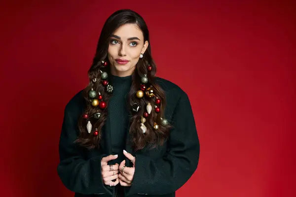 Young woman showcases a creative hairstyle adorned with holiday ornaments, exuding festive charm. — Stock Photo