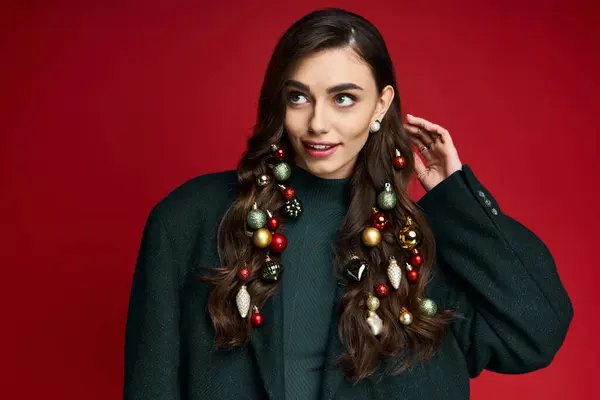 Festively adorned young woman playfully showcases unique holiday hair decorations with a smile. — Stock Photo