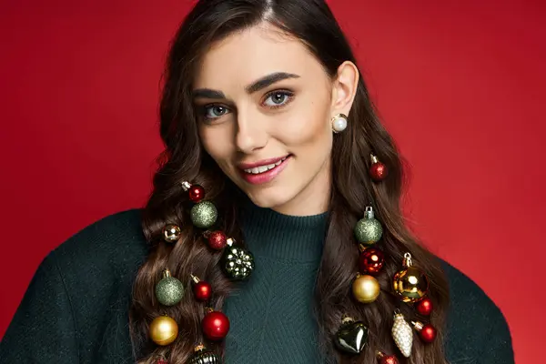 Brightly smiling woman adorned with festive ornaments enjoys a joyful holiday atmosphere. — Stock Photo