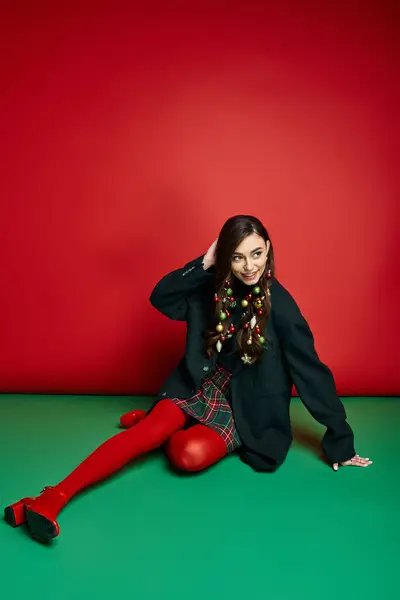 Vibrant atmosphere as a young woman poses cheerfully in stylish holiday outfit. — Stock Photo