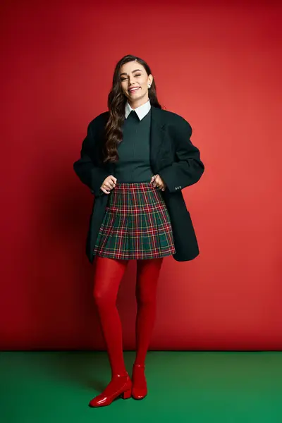 Jeune femme à la mode se tient en confiance dans un ensemble chic, mettant en valeur un style ludique. — Photo de stock