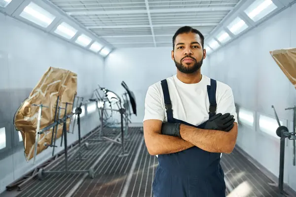 Jovem mecânico está orgulhoso em uma oficina bem equipada, mostrando habilidade e prontidão para o trabalho. — Fotografia de Stock